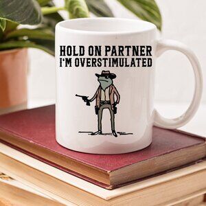 Hold On Partner I'm Overstimulated – Funny Cowboy Frog Meme Mug – 11oz White Mug